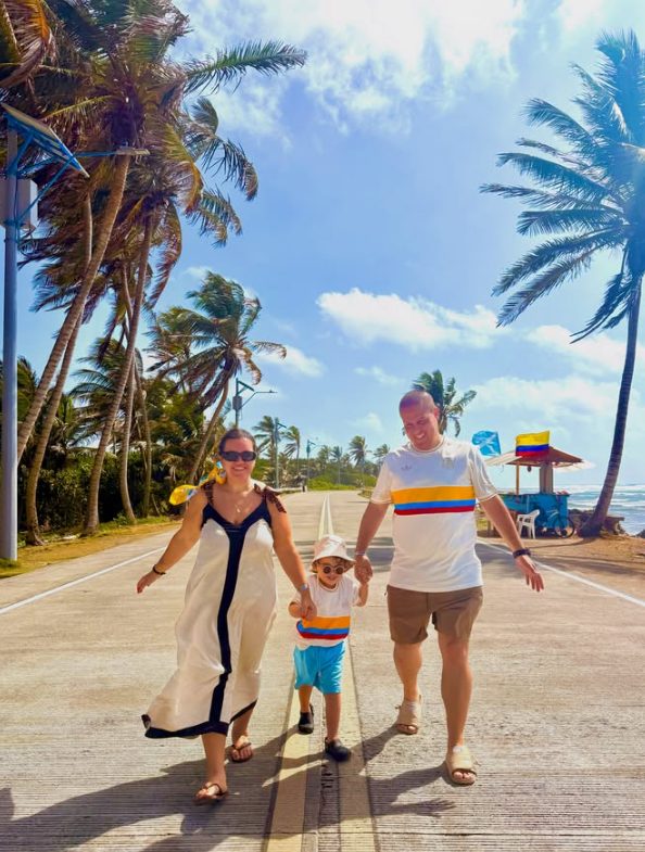 Leo, Pri e Álvaro caminhando por uma estrada cercada de coqueiros, em San Andrés